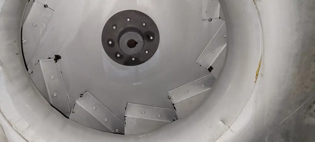 A large blower wheel in a clean white housing